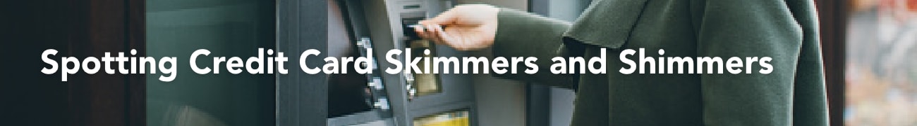 Person inserting a credit card into an ATM